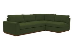 a green sectional couch with wooden legs