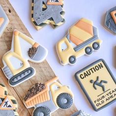 decorated cookies with construction themed icing on a table