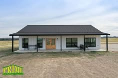 a small white building sitting on top of a dry grass field