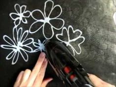 someone is drawing flowers on a chalkboard