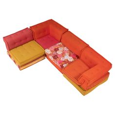 an orange and yellow couch sitting next to each other