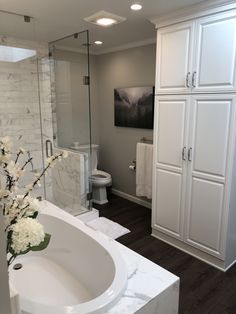 a bathroom with a sink, toilet and shower stall is pictured in this image from the front view