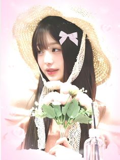 a woman with long hair wearing a hat and holding flowers