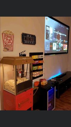 a popcorn machine sitting in front of a flat screen tv