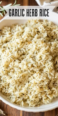 garlic herb rice in a white bowl on a wooden table