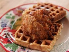 fried chicken and waffles on a plate with a fork