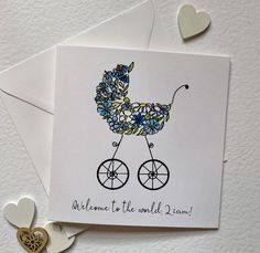 New baby card for a boy with the words ' 'Welcome to the world ( baby's name).' accompanied by a watercolour and ink illustration of a vintage style pram made up of flowers, some centred with pink gem stones for a touch of sparkle.  The card is blank inside for your own message. The card is crisp white 300gsm card  sold with a quality white envelope. It is 13.5 cm squared when closed. Each card will be packed in a hard backed envelope via first class post with Royal Mail. Christian Birthday Cards, Nativity Christmas Cards, Welcome Baby Cards, Vintage Pram, Christian Birthday, Paintings Tutorials, Baby Boy Cards, New Baby Card, Boy Cards