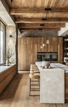 a large kitchen with wooden walls and flooring