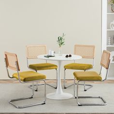 a white table with four chairs around it