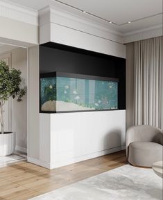 a living room with a fish tank on the wall