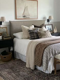 a bedroom with a bed, nightstands and pictures on the wall above it is decorated in neutral colors