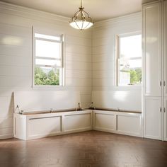 an empty room with white walls and wooden floors