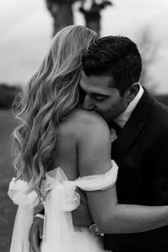 black and white photo of bride and groom embracing each other