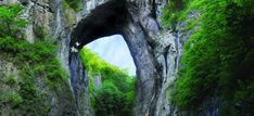 an image of a tunnel in the rock wall that looks like it's going to fall