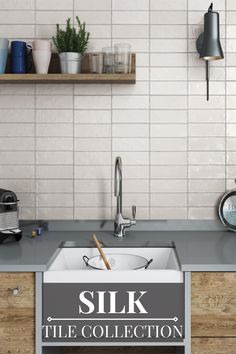 a kitchen sink sitting under a window next to a counter