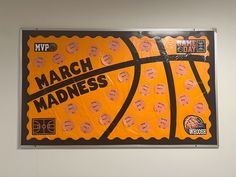 a poster on the wall that says march madness with basketballs written in black and orange