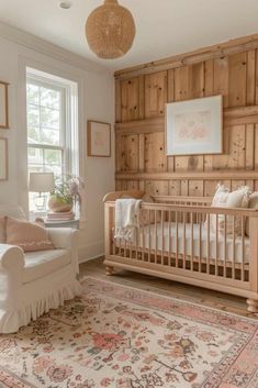 a baby's room with wooden paneling and white furniture