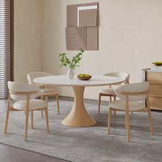 a white table with four chairs around it