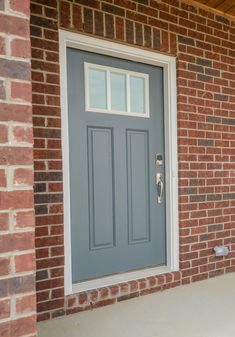 a blue front door on a brick house