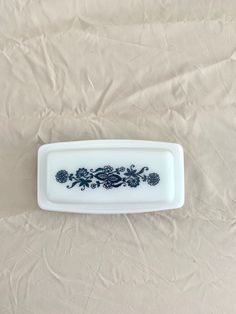 a white and blue plate sitting on top of a bed