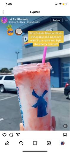 someone holding up a drink in front of a building with an instagramtion message