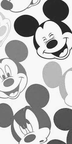 several mickey mouse heads are shown in black and white, including one with an open mouth