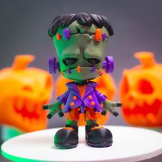 an action figure is posed on a table with pumpkins in the backgroud