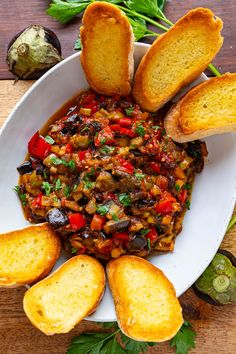 a white plate topped with bread and vegetables