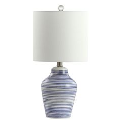 a blue and white striped lamp with a white shade