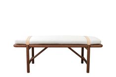 a wooden bench with a white cushion on it