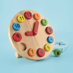 a wooden clock with colorful numbers on it