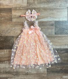 Our Beautiful Peach Sun Dress with Daisy Mesh Overlay is the perfect dress for baby girl to wear for her 1/2 Birthday , First Birthday or just for fun.  Dress would make a perfect gift for any baby girl or mommy expecting a baby girl. Dress is made with a soft peach cotton - Elastic straps and a beautiful Peach Daisy Print Overlay - Big Thick Peach Bow is attached to a soft and stretchy headband. Bow can also be made on a clip if headband is not needed. (you can choose that option at check out ) Sizes available - 6-12 months 12-24 months  3t-4t  *PROCESSING TIME: We ship 1-2 business days. You can see the exact shipping dates in your receipt. Please convo us if you need for specific date and leave your date needed by at check out in the note to seller box.  *SHIPPING: Regular First Class Groovy One, First Birthday Outfit, Headband Bow, Daisy Dress, 2 Birthday, Stretchy Headbands, Fun Dress, First Birthday Outfits, Expecting Baby