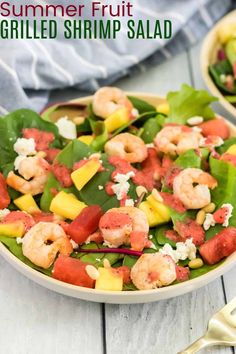 a salad with shrimp, pineapples and spinach