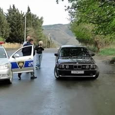 two police cars parked next to each other on a road