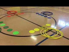 a close up of a basketball court with circles and rings on the floor in front of it