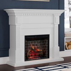 a white fireplace with blue walls and a painting on it's wall above the fire place