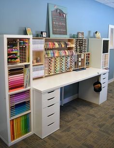 an office desk with lots of craft supplies on the top shelf and drawers below it