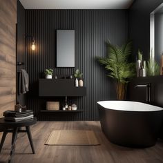 a black and white bathroom with a large bathtub next to a plant in the corner