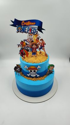 a three tiered cake decorated with cartoon characters on it's sides and a banner above the top