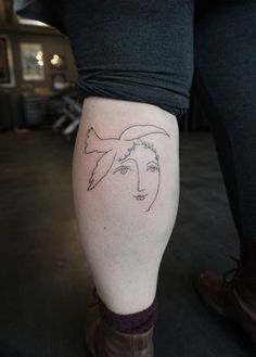 a woman's leg with a tattoo on it