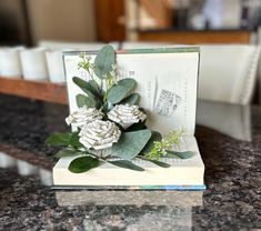 a book with some flowers on top of it