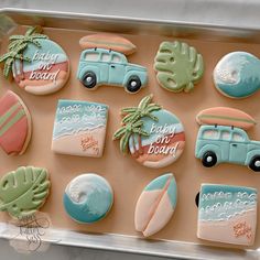 decorated cookies in the shape of cars, surfboards and palm trees