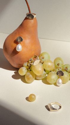 a pear and some grapes on a table