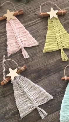 small christmas tree ornaments made out of yarn and twine on a wooden table top