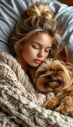 a woman laying in bed next to a dog with her eyes closed and head resting on the pillow