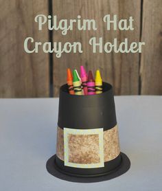 a paper hat with crayons sticking out of it and the words pilgrim hat crayon holder