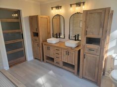 a bathroom with double sinks and wooden cabinets