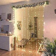 a living room filled with furniture and lots of christmas lights on the wall above it