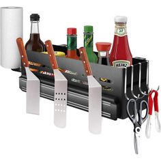 a knife holder with knives and condiments hanging from it's side on a white background