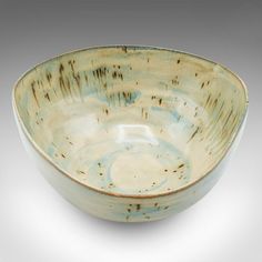 a white and blue bowl sitting on top of a table